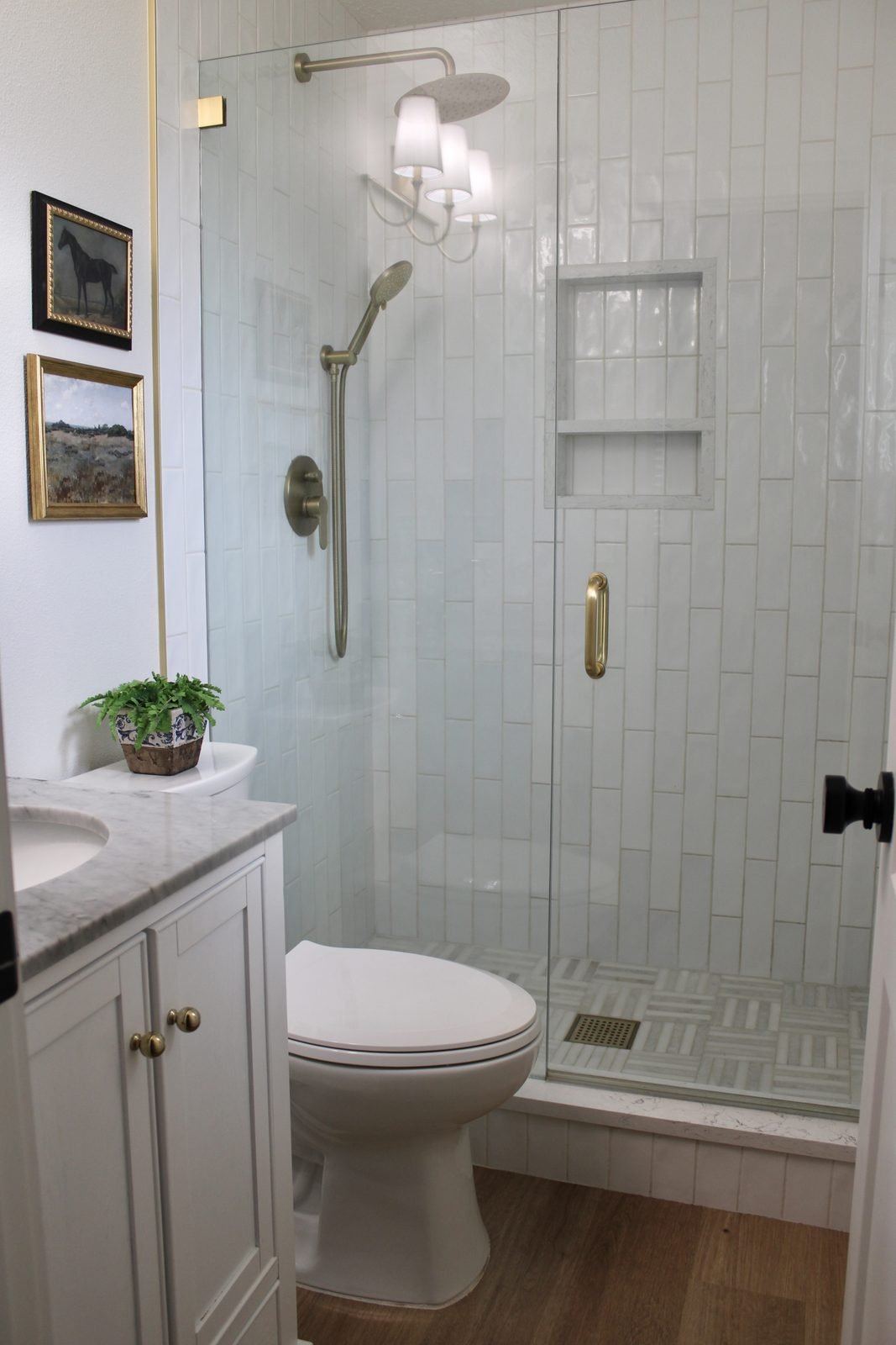 Walk-in shower with vertical tile and marble vanity in Lakeland, FL